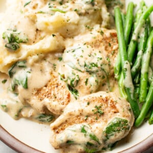 a plate with cream of mushroom soup pork tenderloin, green beans, and mashed potatoes