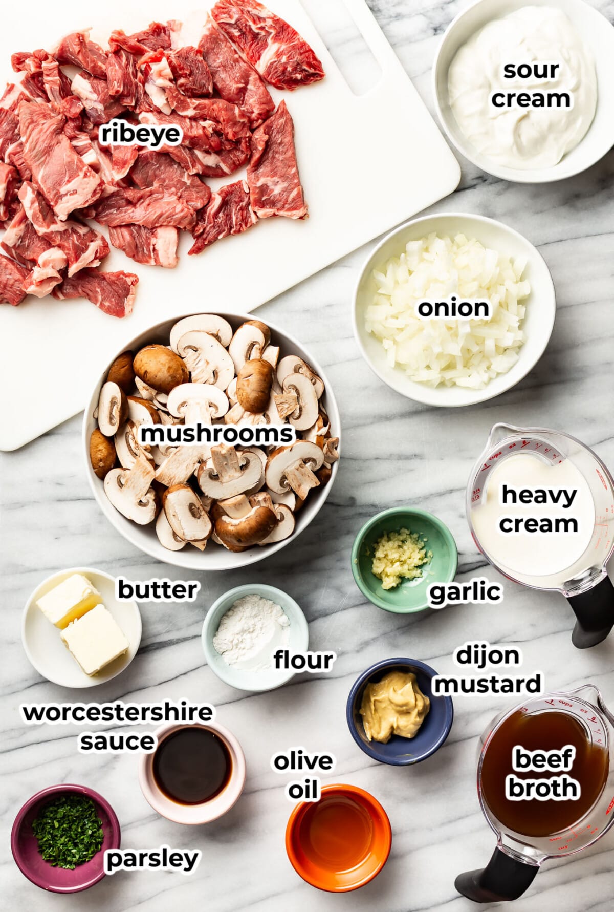 ingredients for beef stroganoff in prep bowls