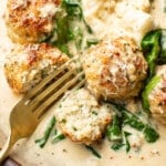 a plate with chicken florentine meatballs and a fork