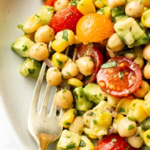 a bowl of chickpea salad with a fork