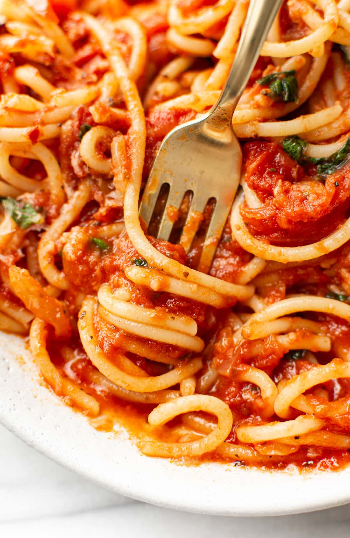 a bowl of tomato spaghetti with a fork