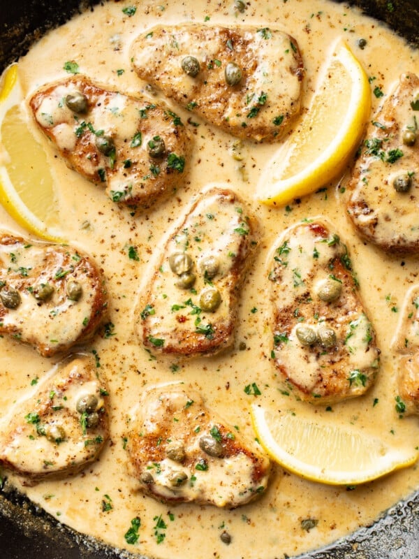 a skillet with pork tenderloin piccata