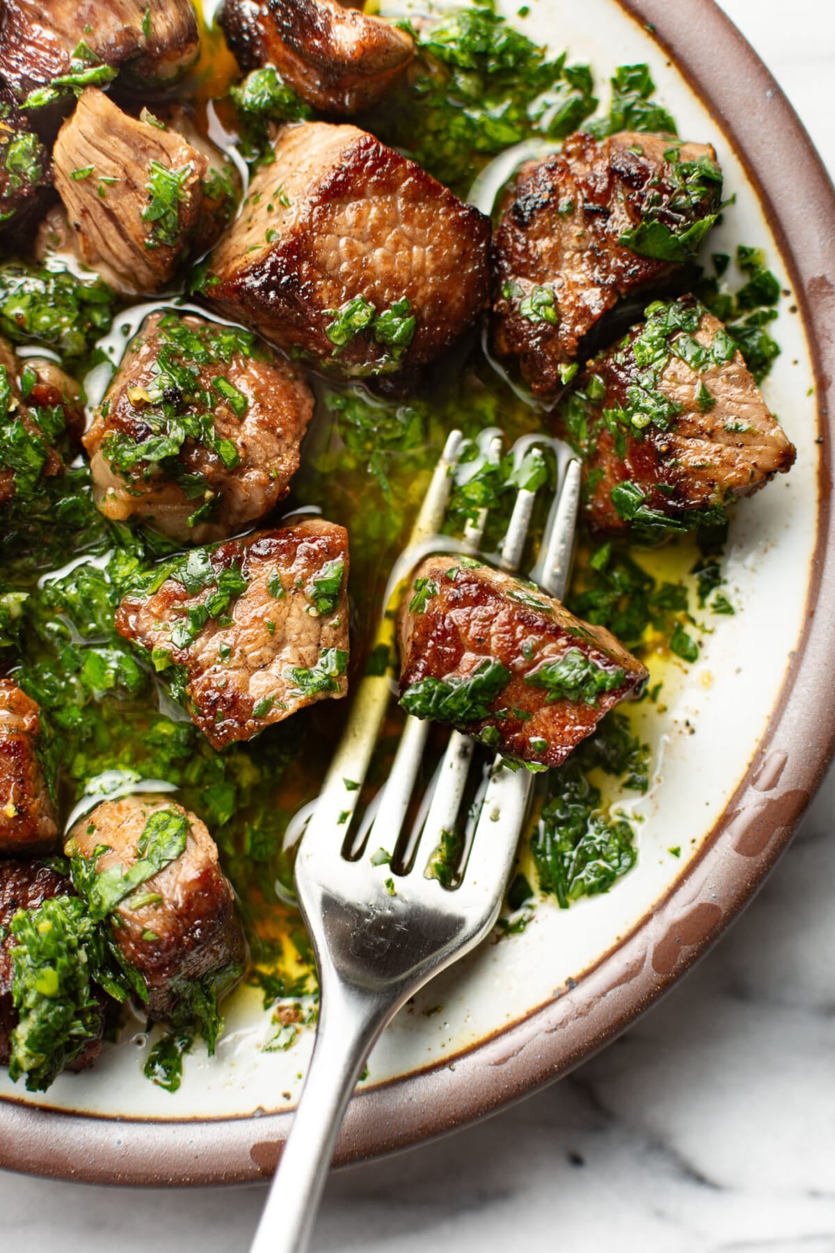 a plate with steak bites coated in gremolata