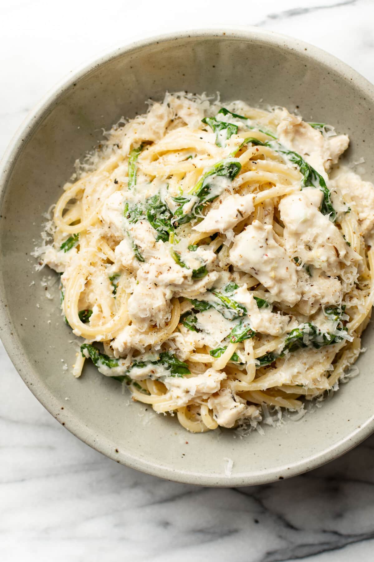 a bowl of lemon spinach chicken pasta