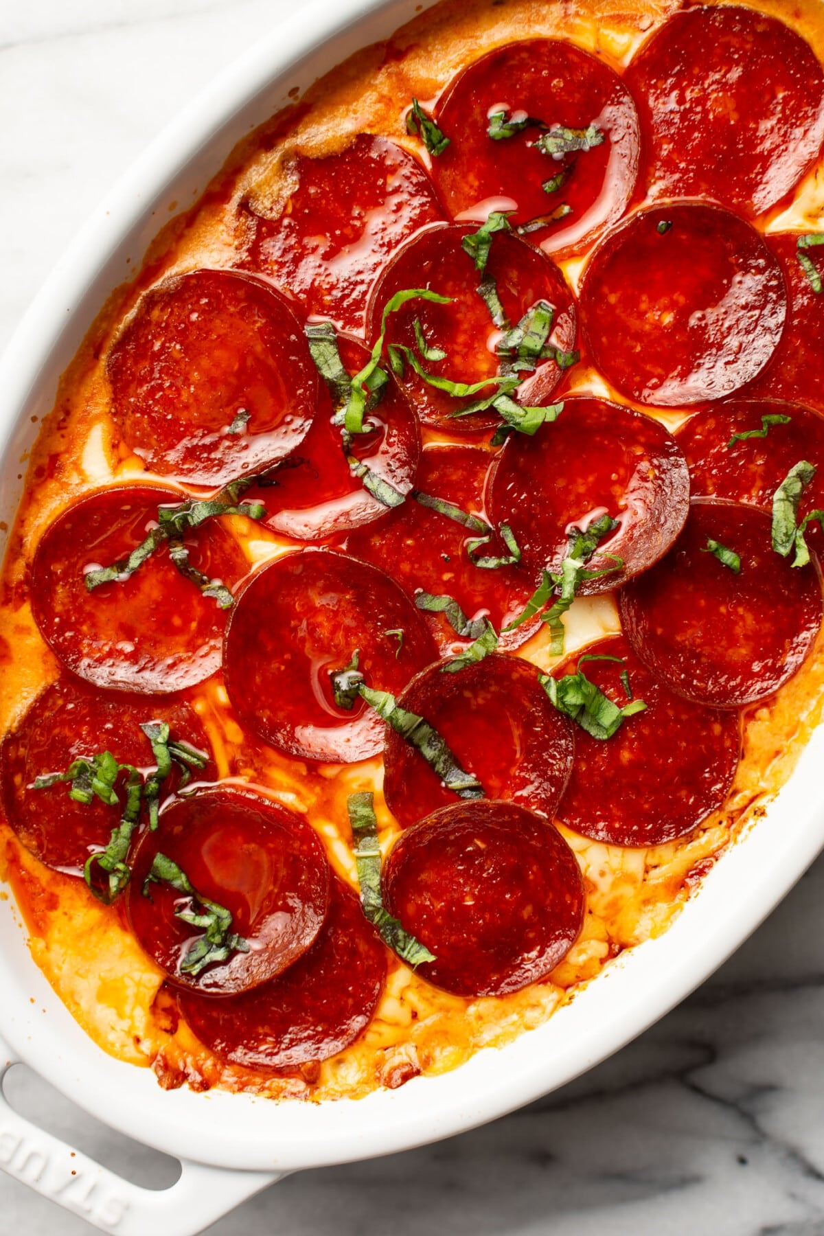a baking dish with pepperoni pizza dip