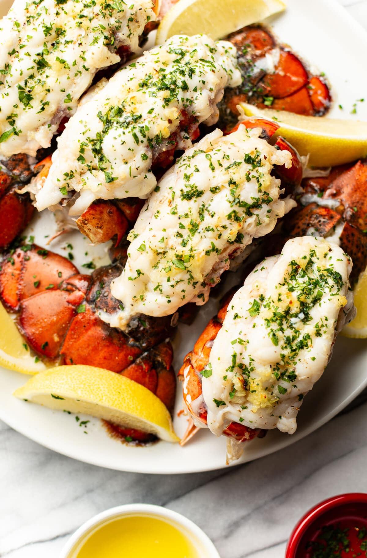 a plate with garlic butter lobster tails